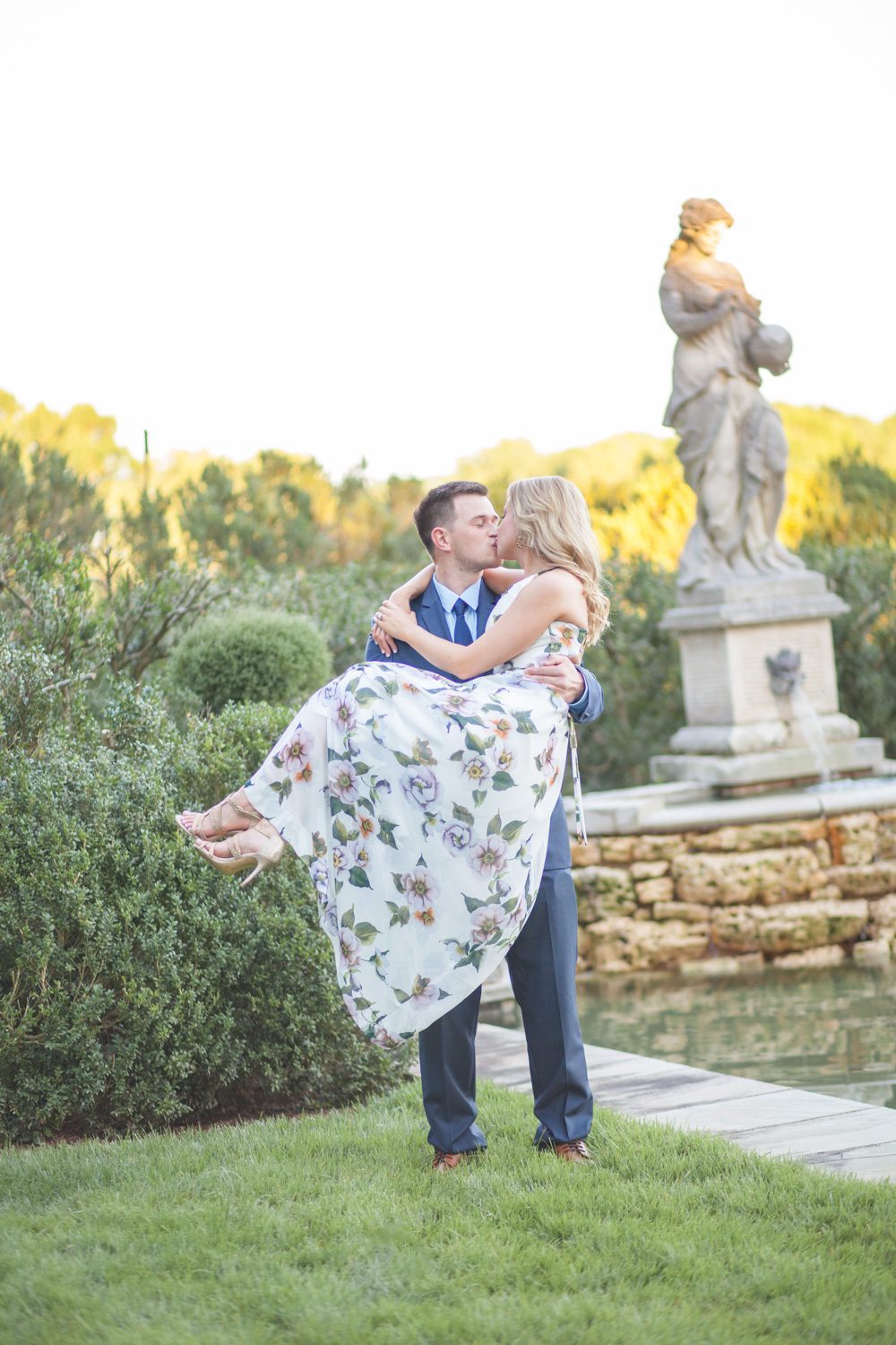 couple by reflection pool engagement session at cheekwood estate and gardens