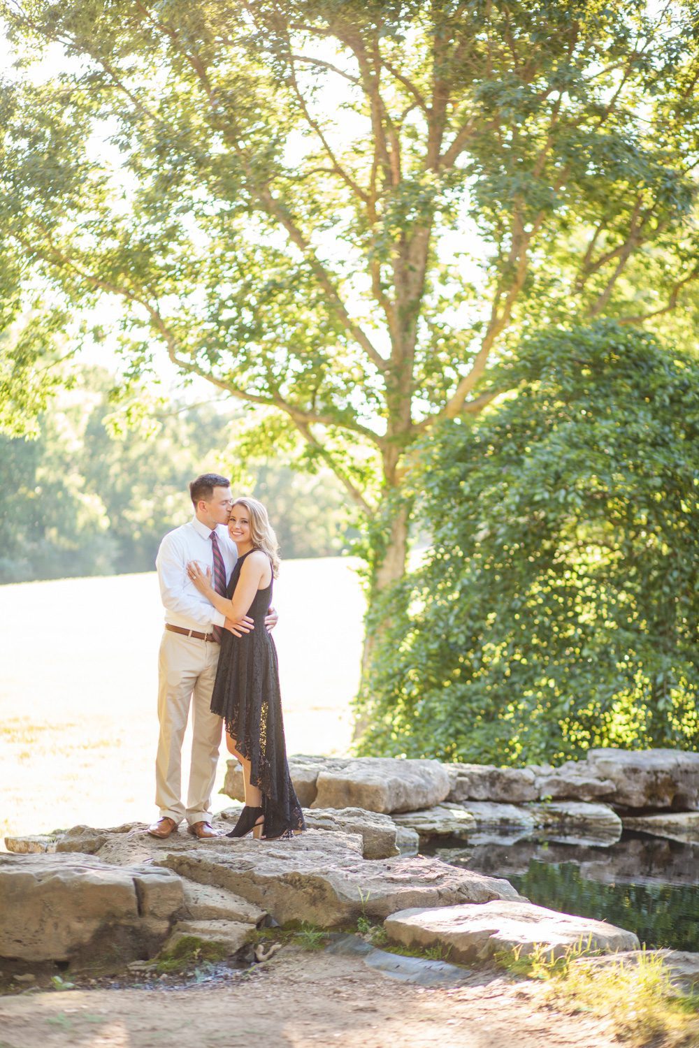 couple by waterfalls and pond during engagement session at cheekwood estate and gardens photo by krista lee photography