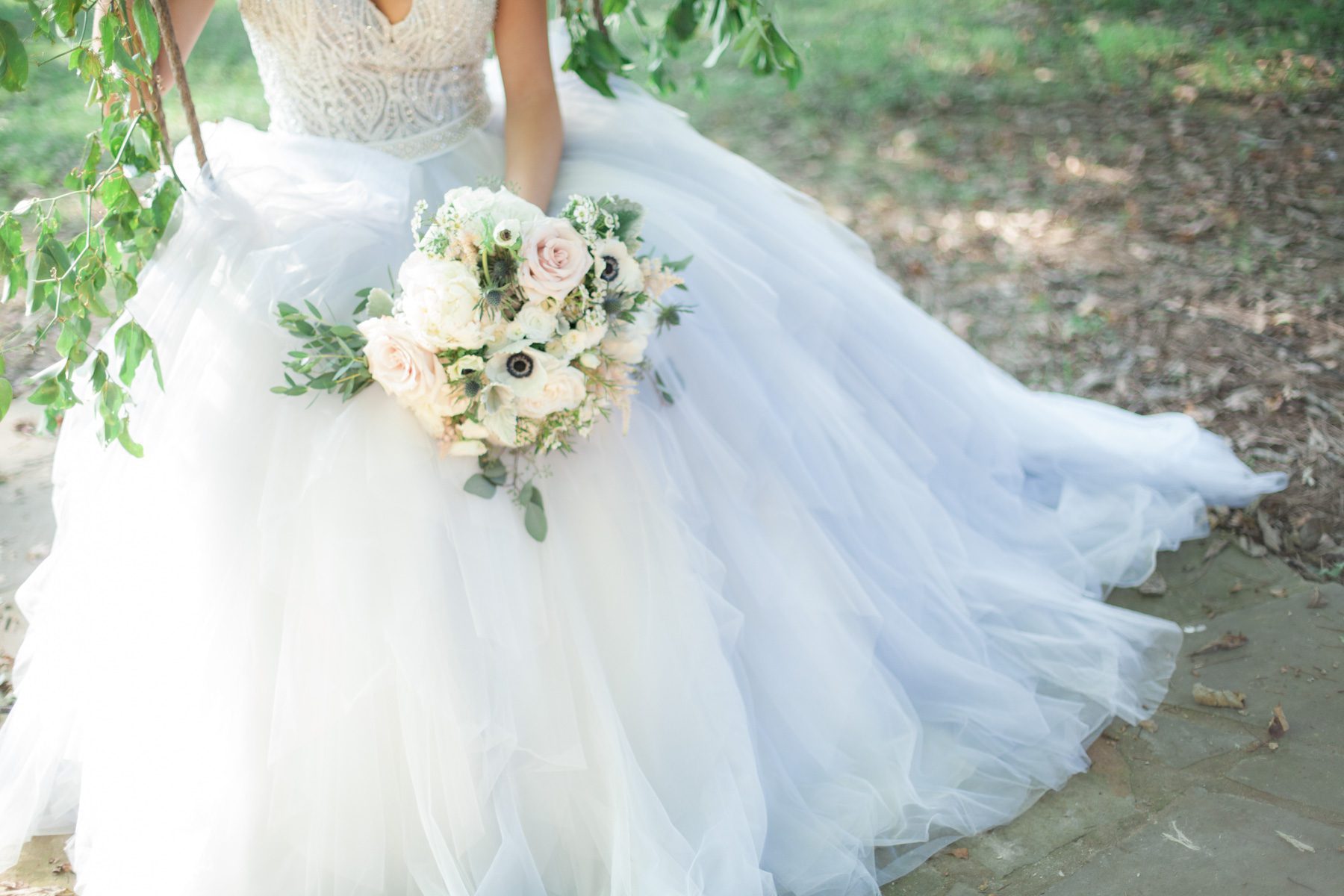 Bride's dress and flowers on swing. Wedding photography at Cedarwood Weddings and Estate in Nashville, TN photography by Krista Lee Photography