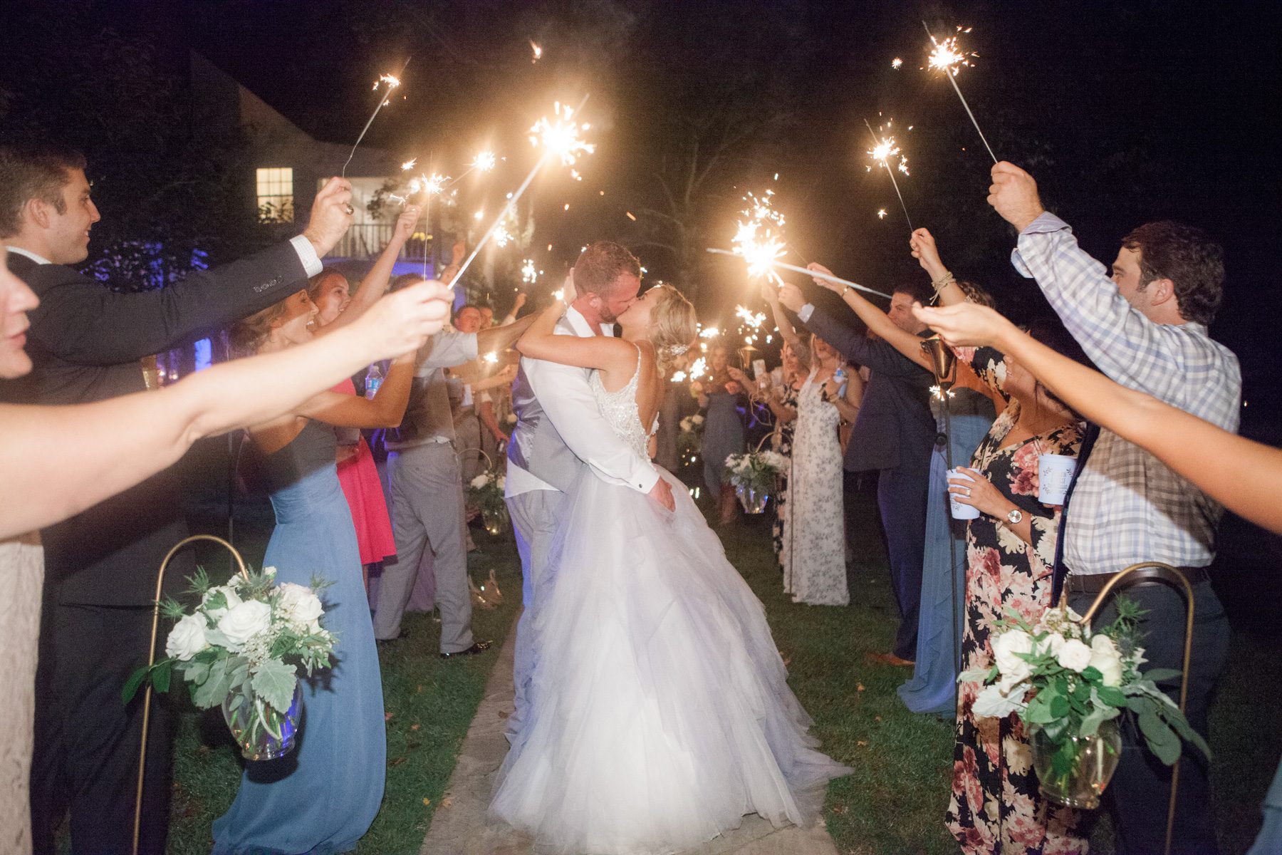 Photo of bride and groom kissing at sparkler exit during wedding reception. Wedding photography at Cedarwood Weddings and Estate in Nashville, TN photography by Krista Lee Photography