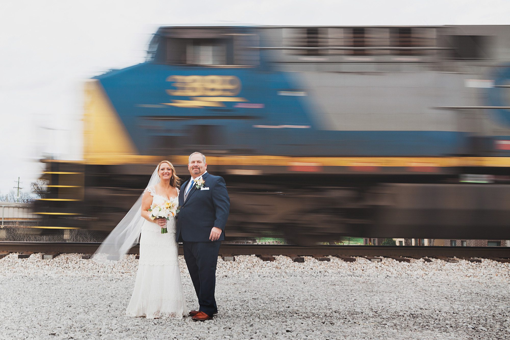 Bride and groom portrait with speeding train in background before wedding ceremony  at Houston Station, Nashville TN. Photos by Krista Lee Photography.