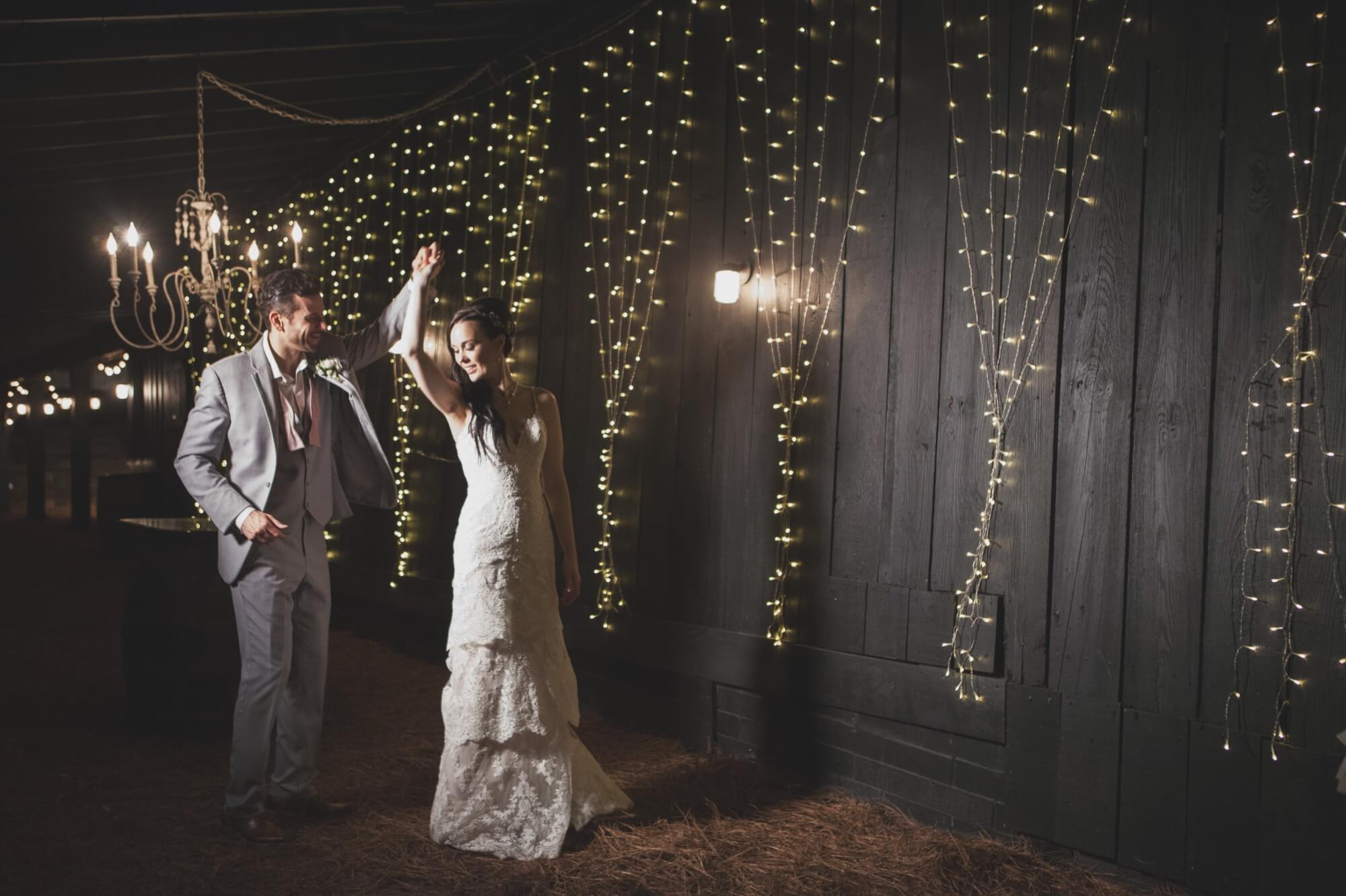 Groom spins bride in the reception barn after their wedding ceremony at David and Jennifer's Cedarwood spring wedding in Nashville TN, photography by Krista Lee. 