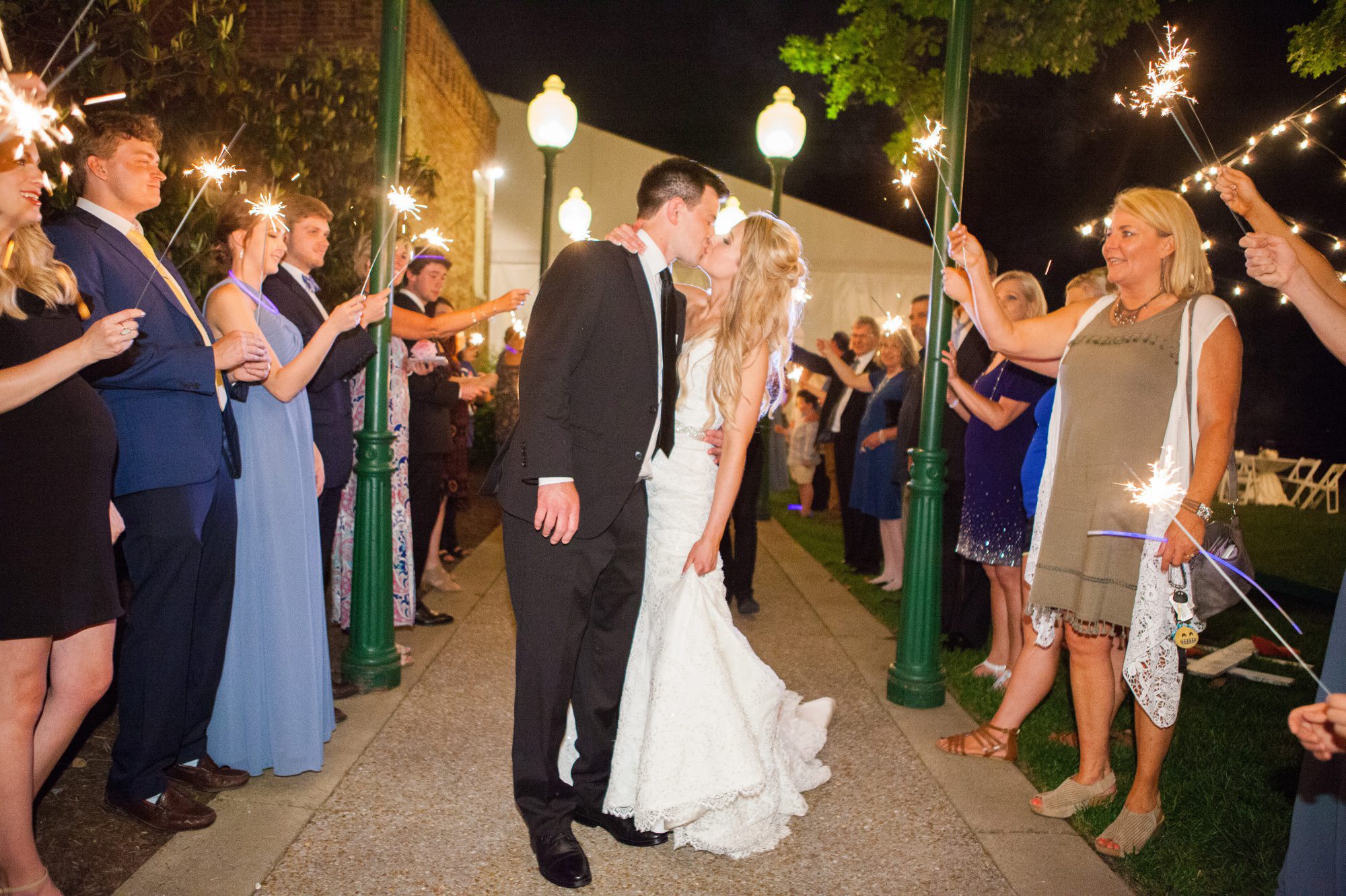 Bride and groom kiss at sparkler exit Riverwood Mansion in Nashville, Tennessee. Photography by Krista Lee.