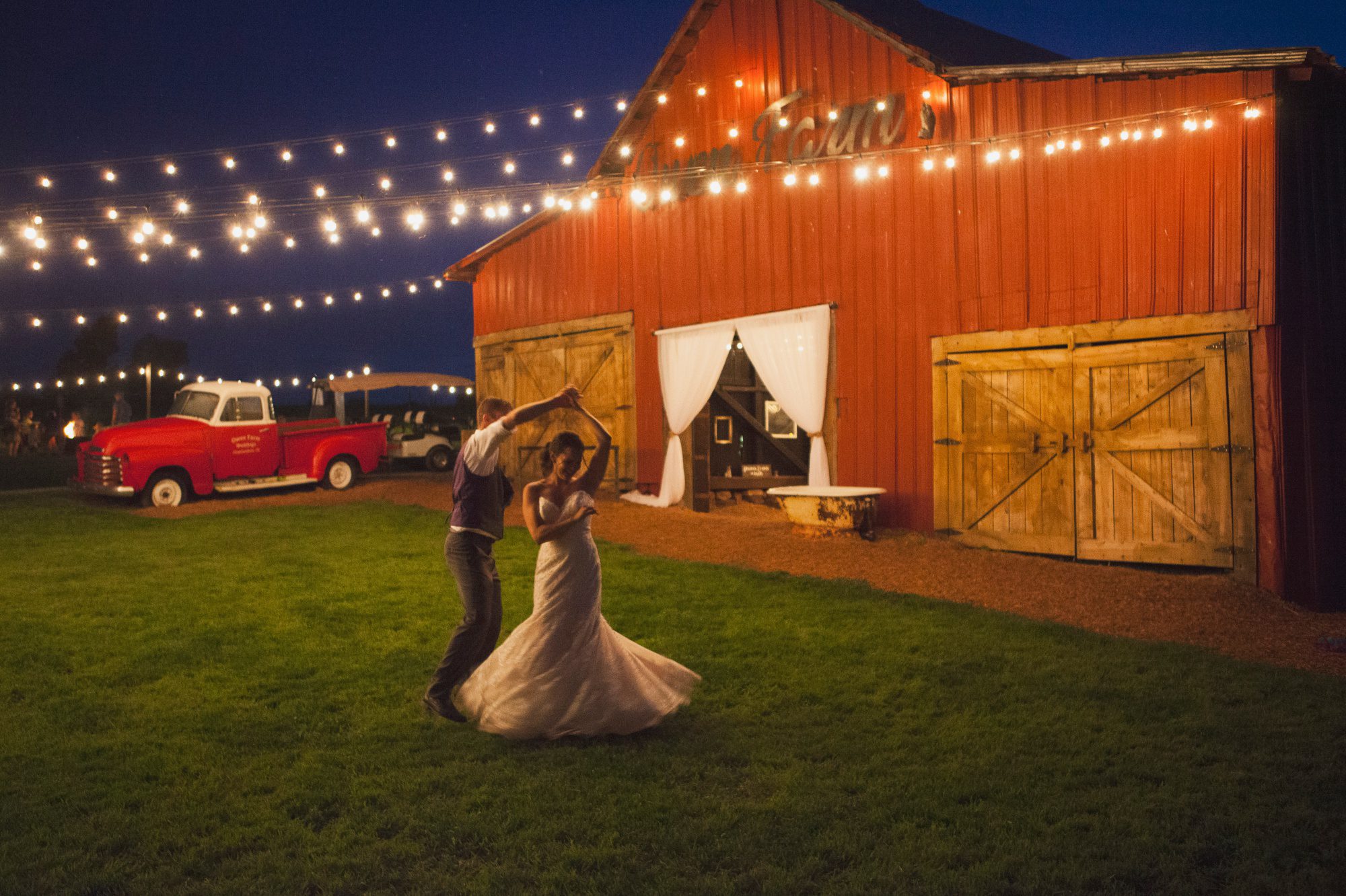 Moonlit portrait of bride and groom dancing by barn after reception at summer wedding at Owen Farm in Chapmansboro, TN. Photography by Krista Lee Photography. 