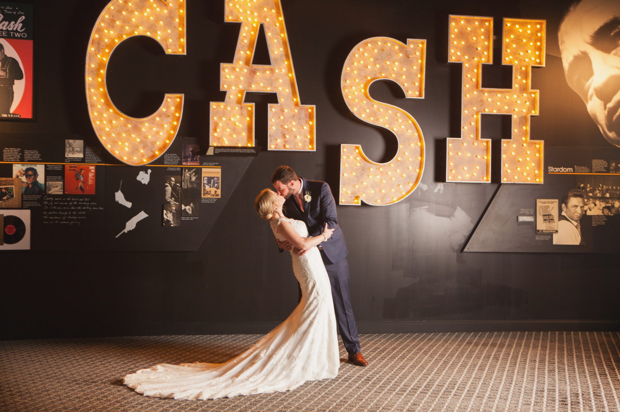 Bride and groom wedding photo with Johnny Cash wall before wedding photography at Musicians Hall of Fame in Nashville TN photos by Krista Lee 