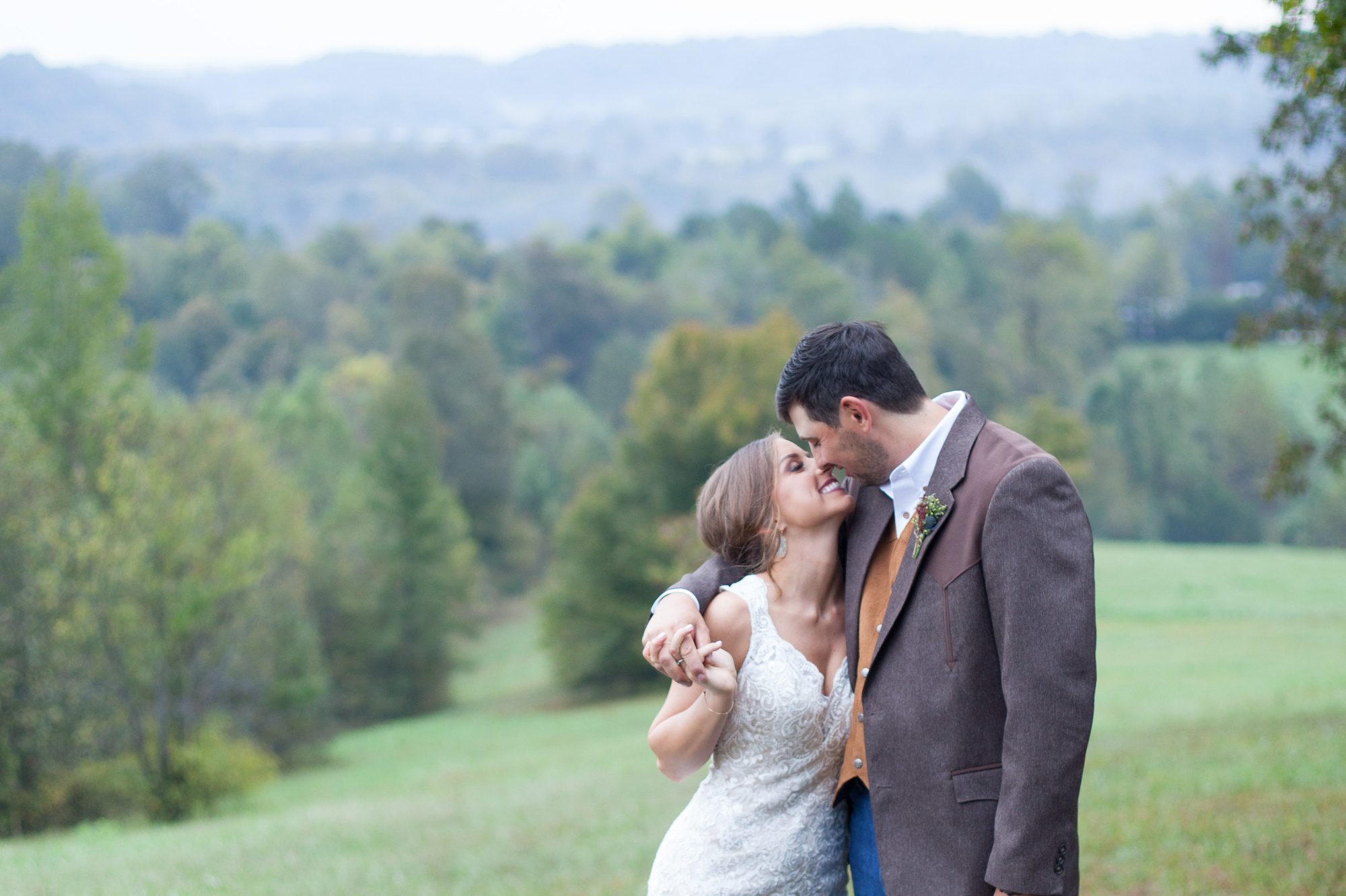 Bride and groom do portraits with hills in background after wedding ceremony photography at Front Porch Farms, Wedding photography by Krista Lee