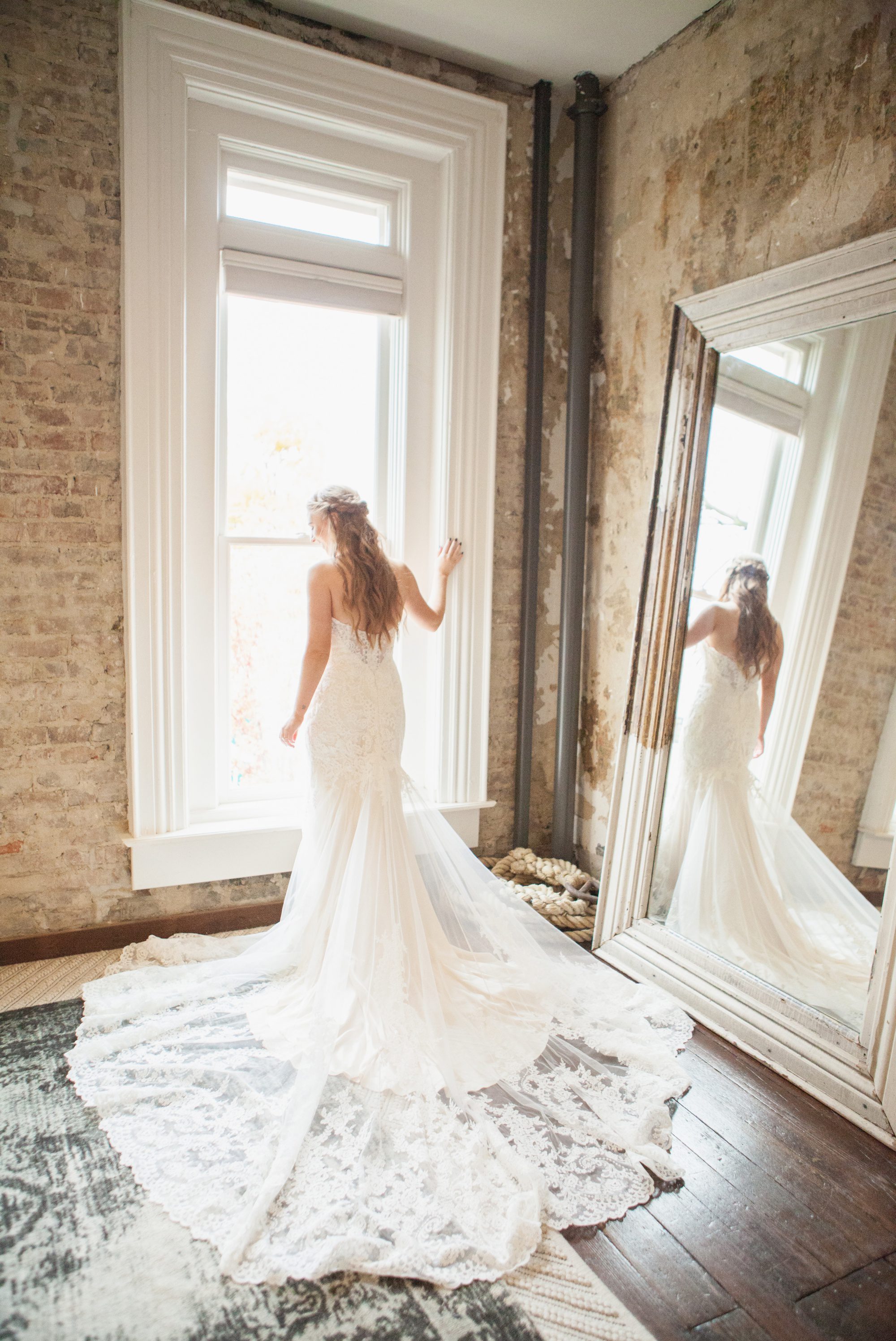 Bride looks out window upstairs at Caitlin and Brett's Fall Wedding at Cordelle Nashville TN. Planner Ellen Hollis, photographer Krista Lee Photography. 