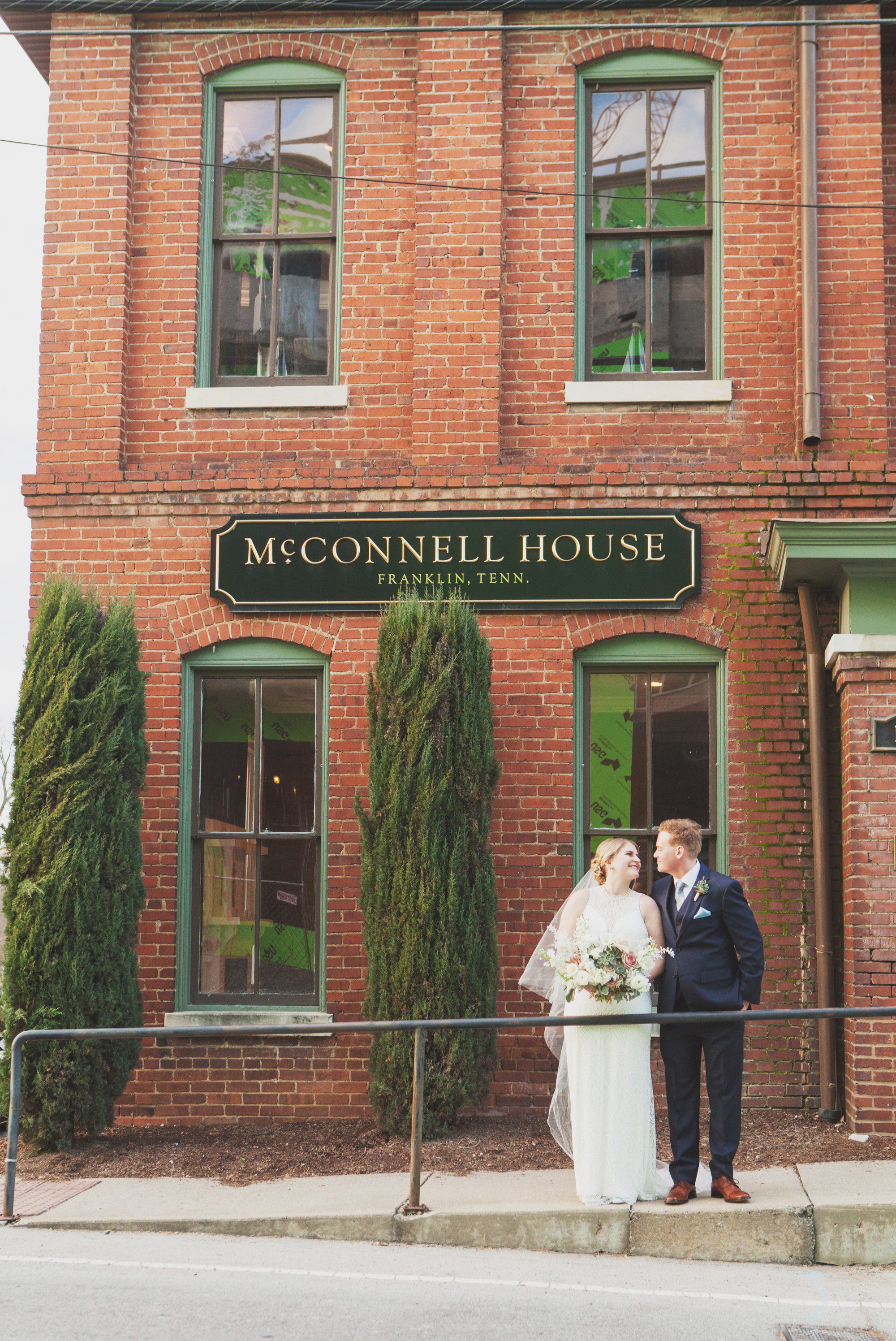 Bride and groom on front porch at McConnell House in Franklin, TN before wedding ceremony. Photos by Krista Lee Photography Nashville, TN