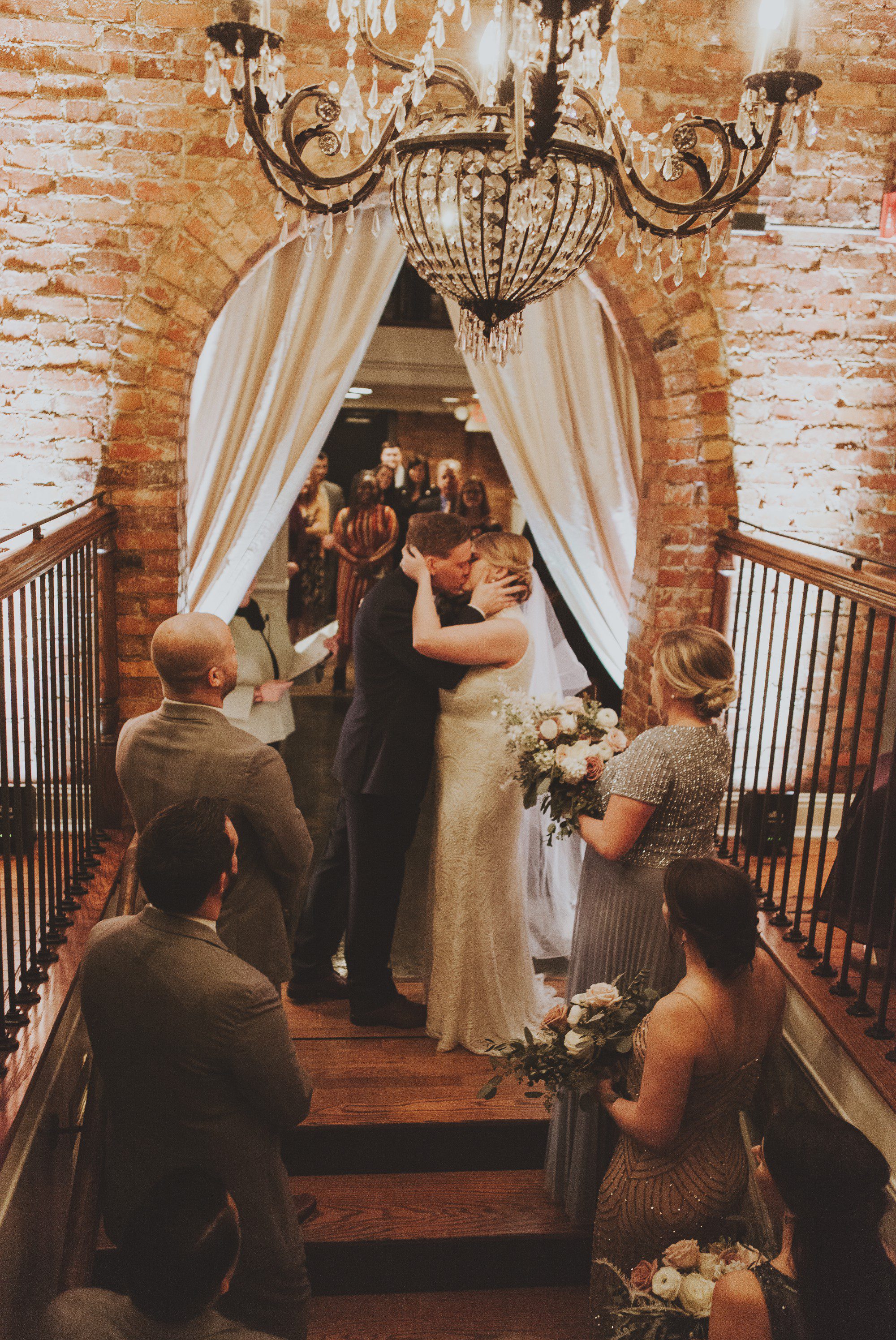 Beautiful wedding ceremony on stairs underneath chandeleir at McConnell House in Franklin, TN before wedding ceremony. Photos by Krista Lee Photography Nashville, TN