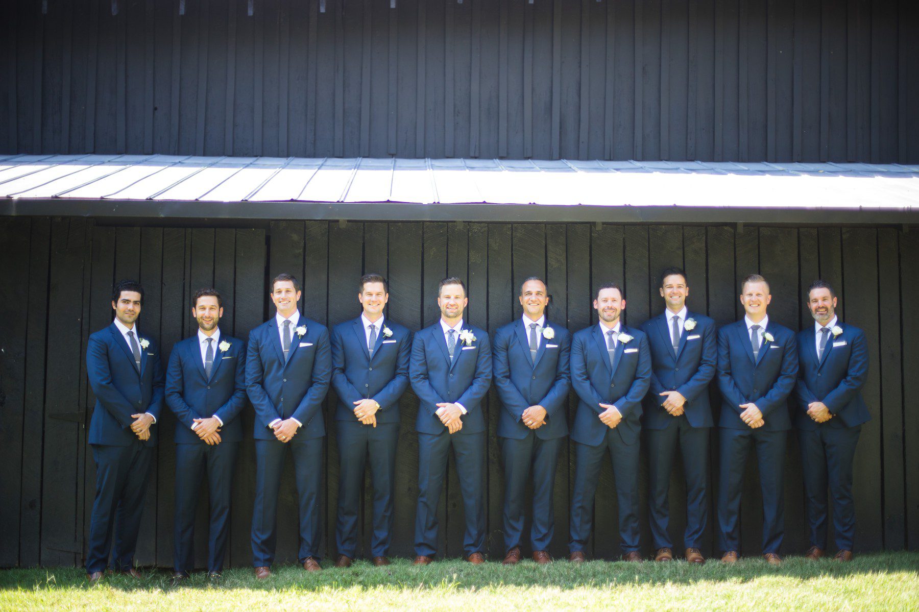 groomsmen pose for photos at estate venue and barn in nashville