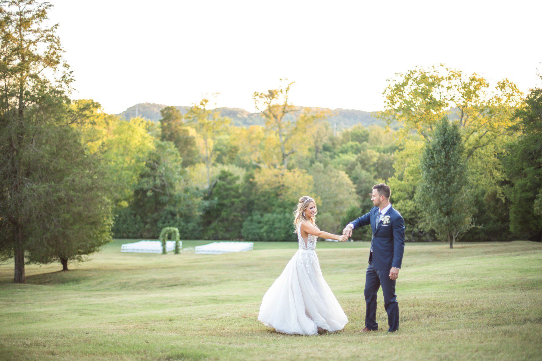 bride and groom dance at outdoor wedding with rolling tennessee hills in the background