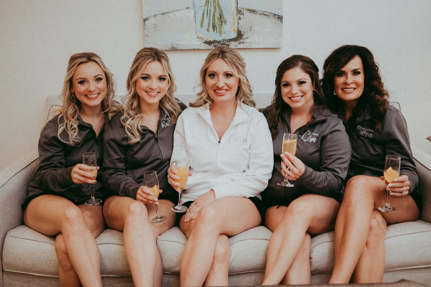 bride with bridesmaids relaxing before wedding 