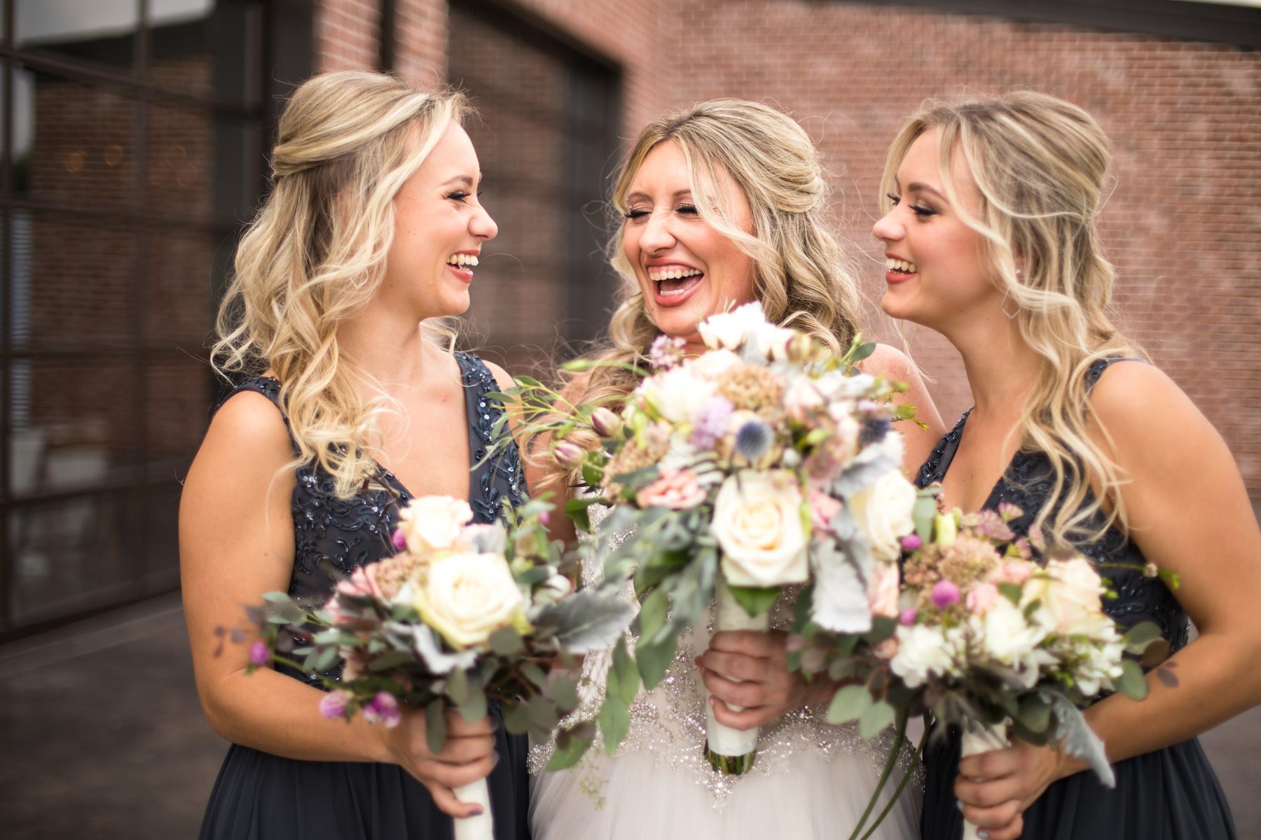Bride laughing with bridesmaids Clarksville, TN Old Glory Distilling Go.