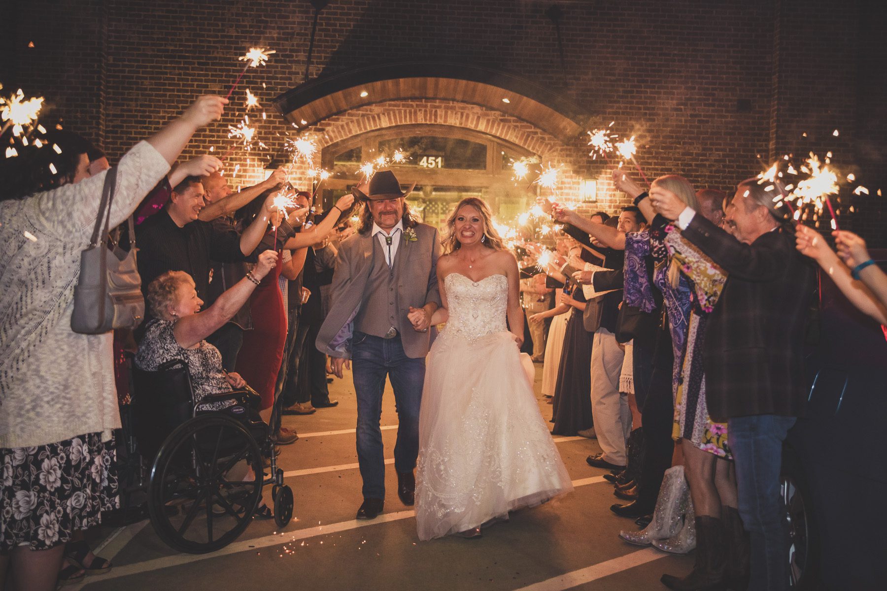 bride and groom leave reception with sparkler exit Old Glory Distilling Co. 