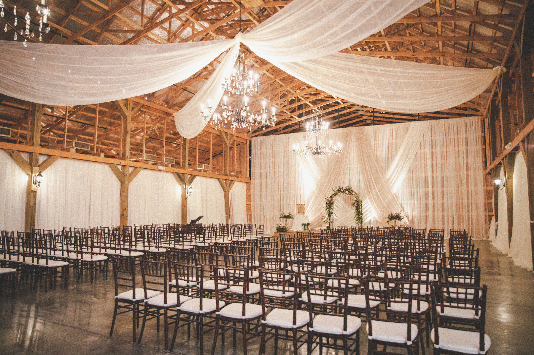 Saddle Woods Farm Wedding draping at indoor barn ceremony venue 
