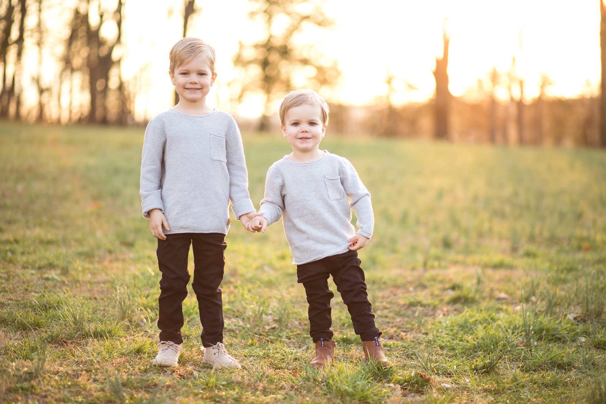 Children brothers portrait photo in field at sunset 