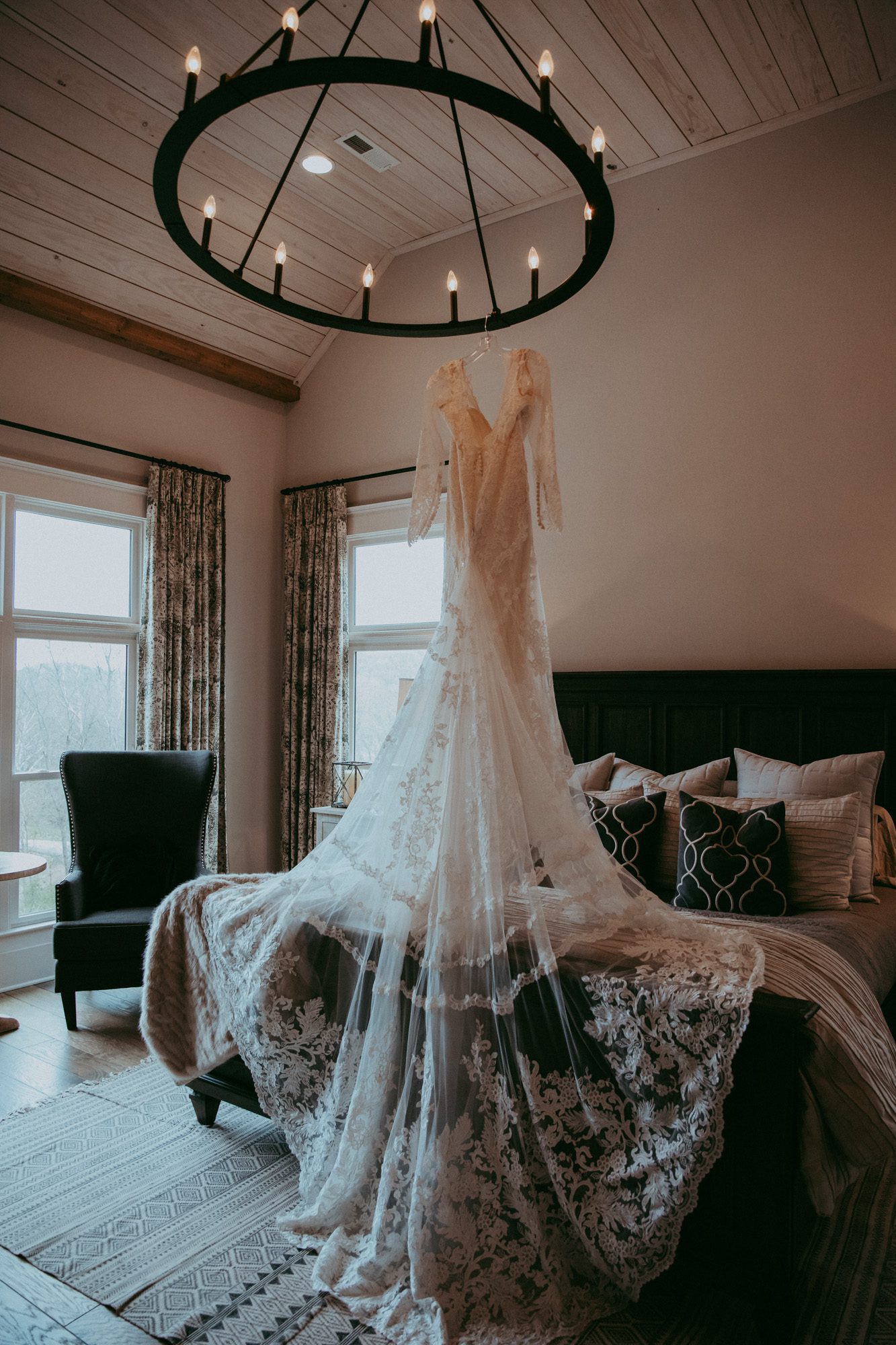 Wedding dress hanging from chandelier before wedding 