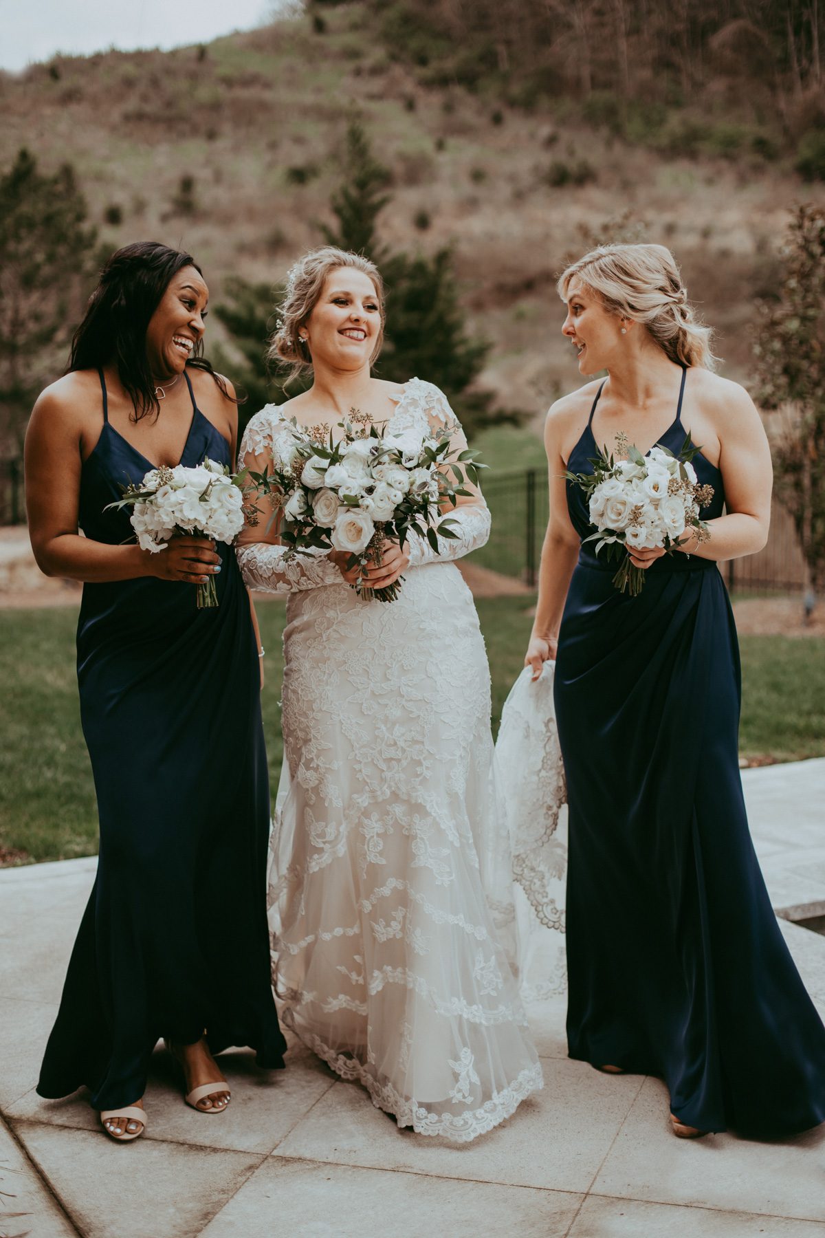 Candid wedding photography with bride and bridesmaids hanging out 