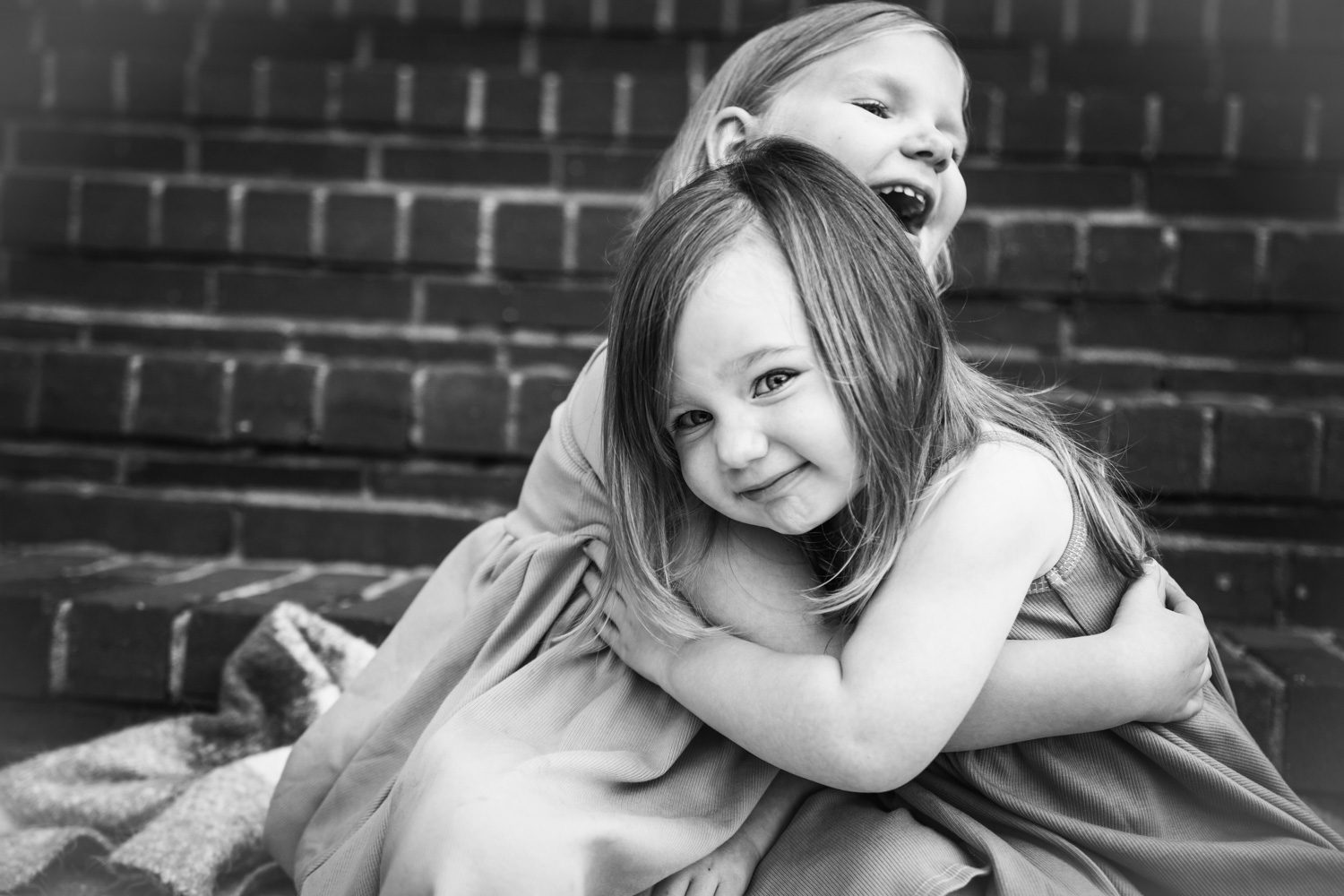 Sisters give each other a hug during family photos at A&E Farm in College Grove TN