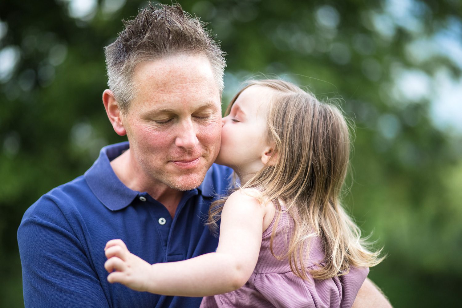 Candid little girl giving daddy a kiss A&E Farm in College Grove TN