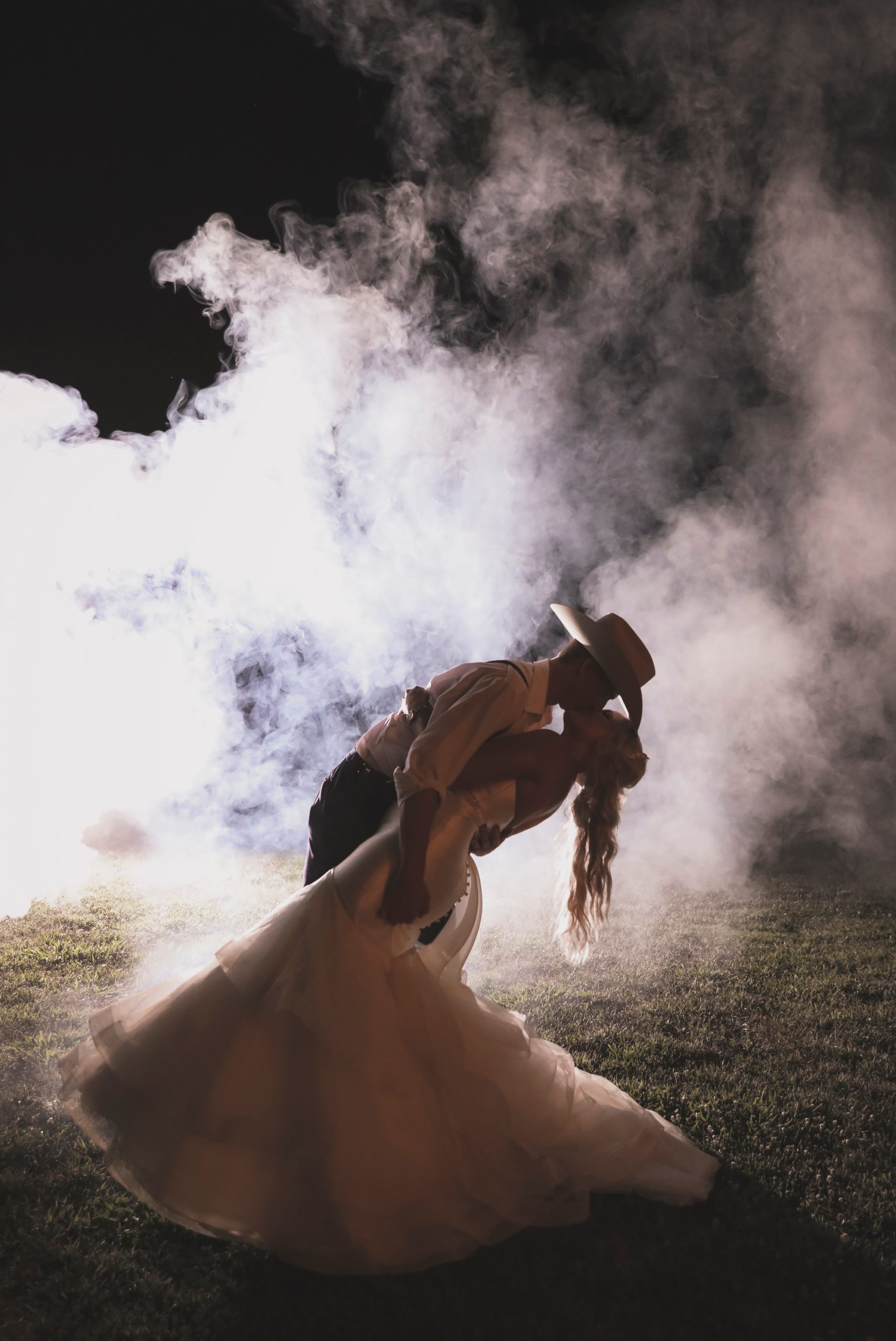 Romantic sexy wedding portrait with smoke bomb at night