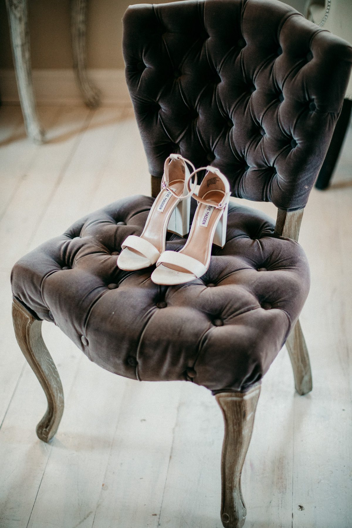 brides Steve Madden shoes sit on velvet chair before wedding ceremony at Front Porch Farms Charlotte TN
