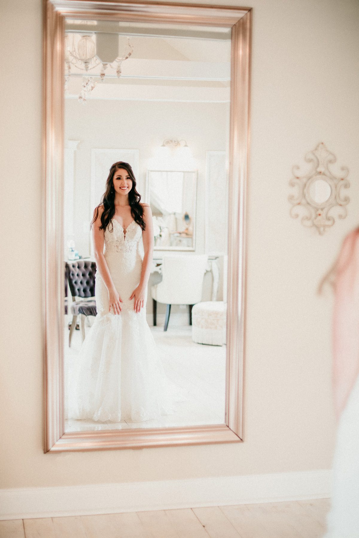 Bride's reflection in mirror Stella York gown 