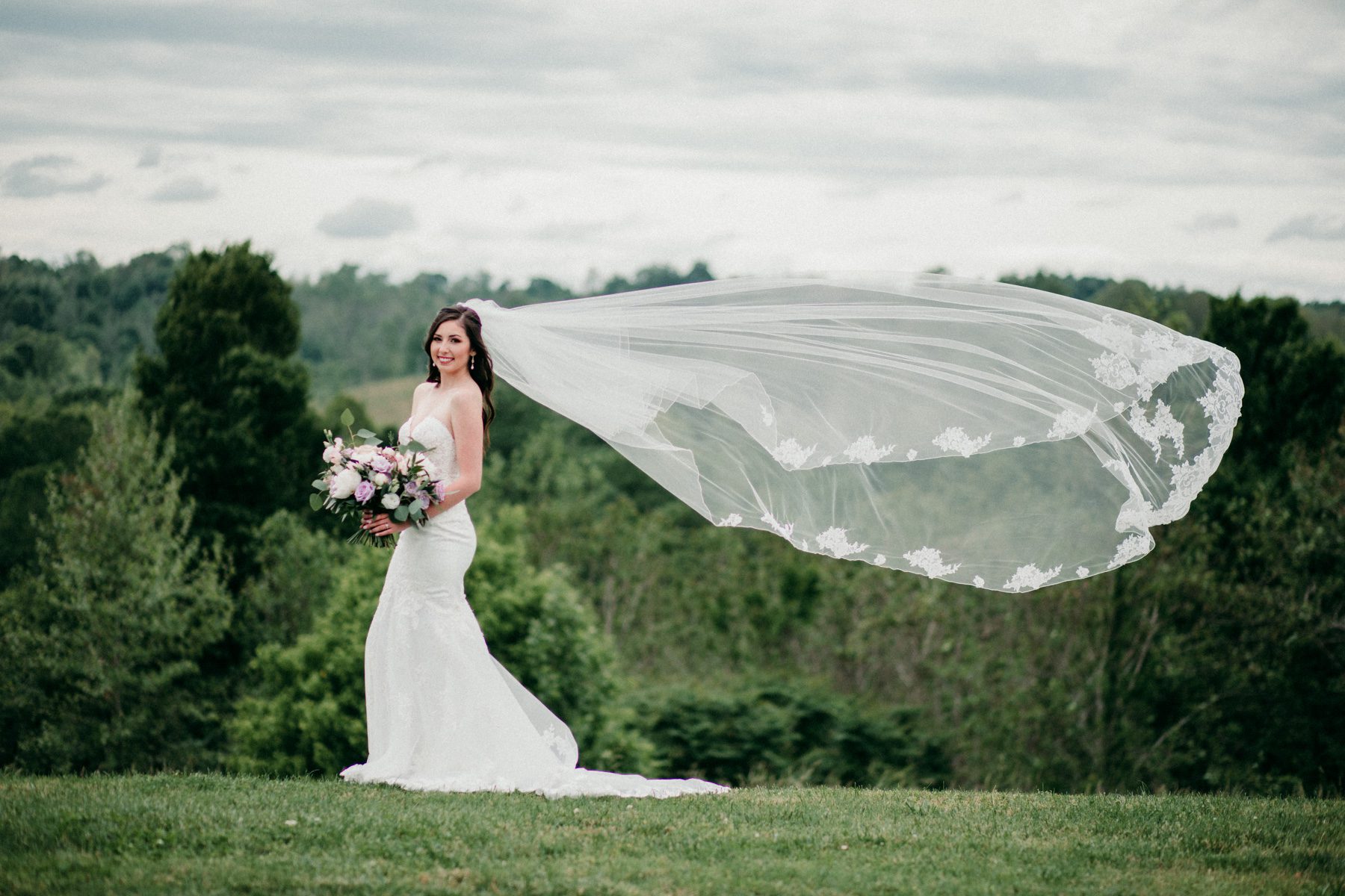 Stunning outdoor bridal portrait with veil 
