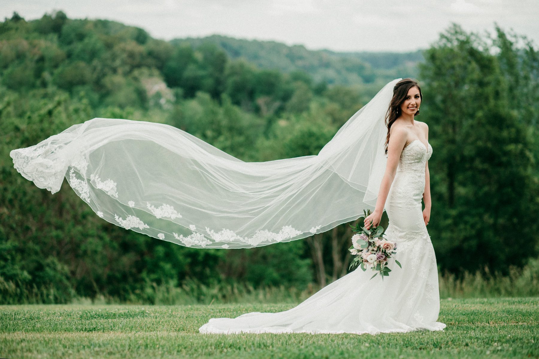 Outdoor bridal portrait in strapless lace Stella York dress 