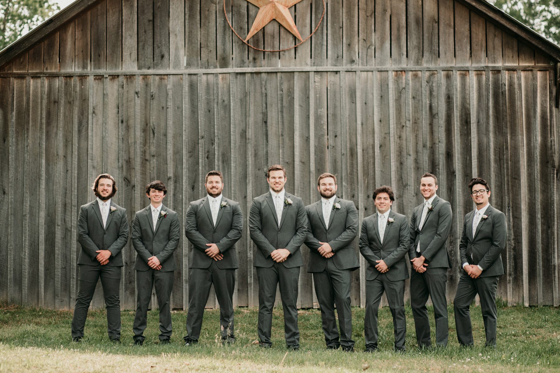 Groomsmen with barn on wedding day 