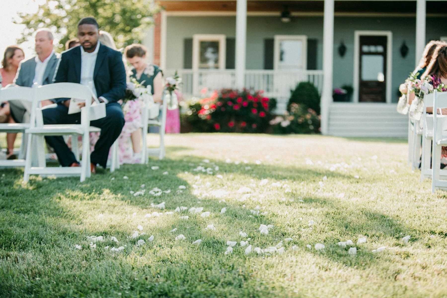 Rose petals in aisle for outdoor wedding ceremony 