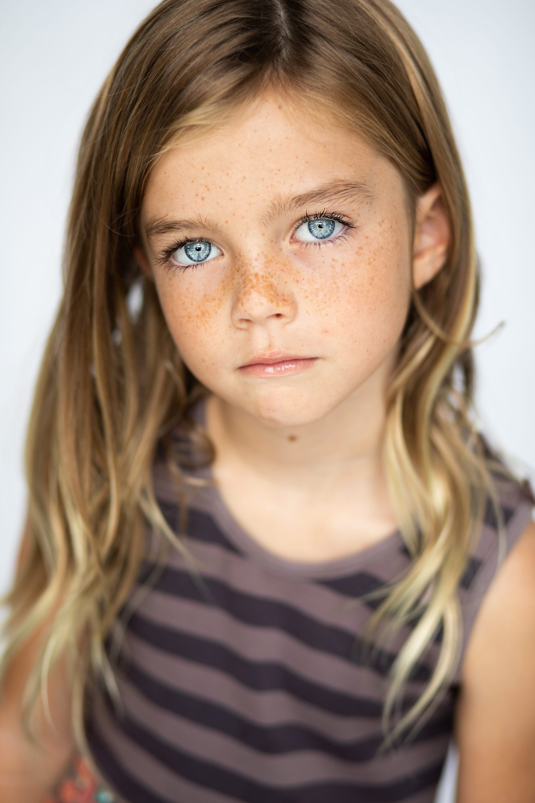 Natalie poses for a kids actor headshot session in Nashville TN, such pretty blue eyes