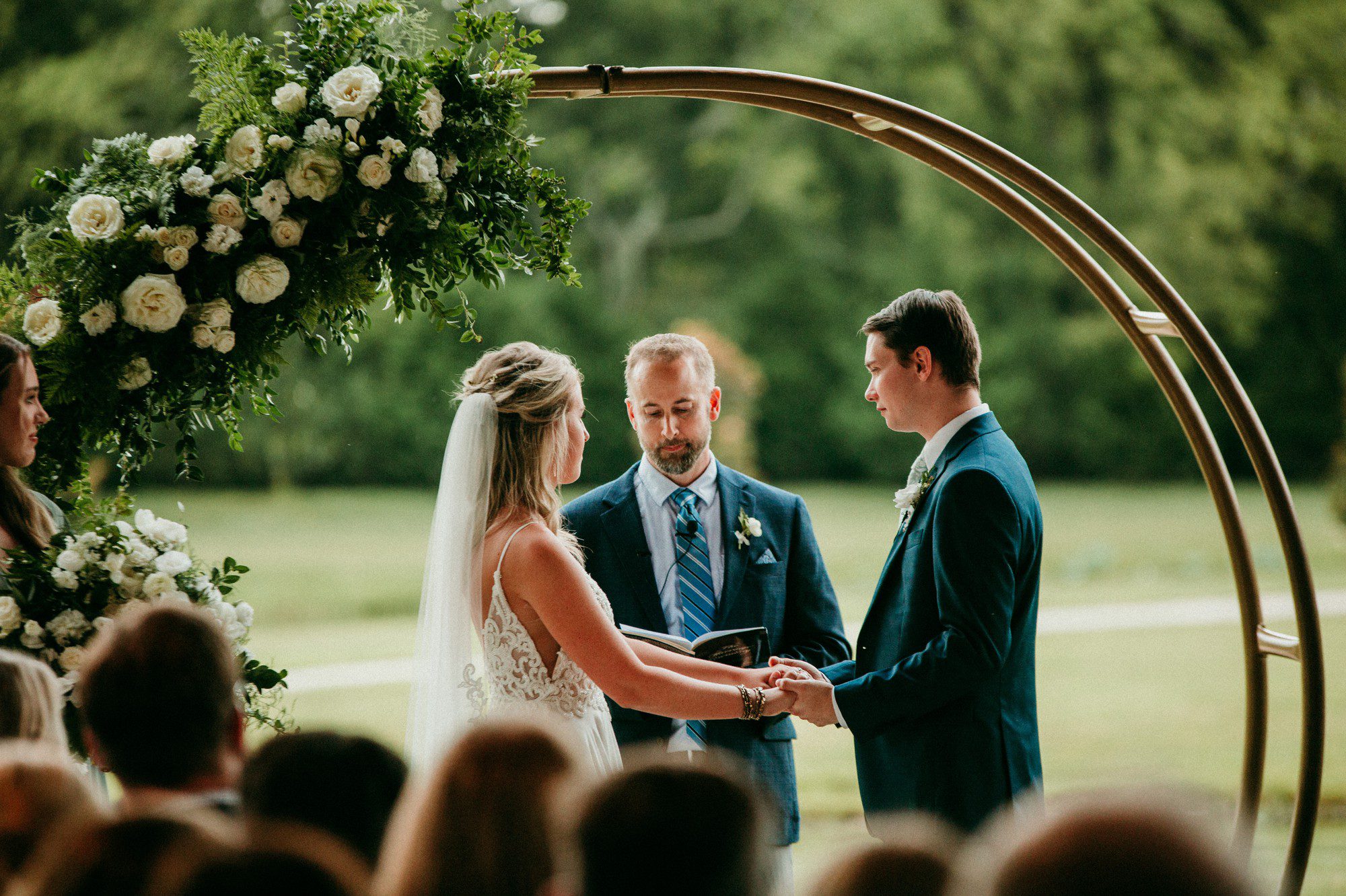 Circle wedding arch with offset white and greenery floral piece at The Barn at Sycamore Farms Arrington, TN