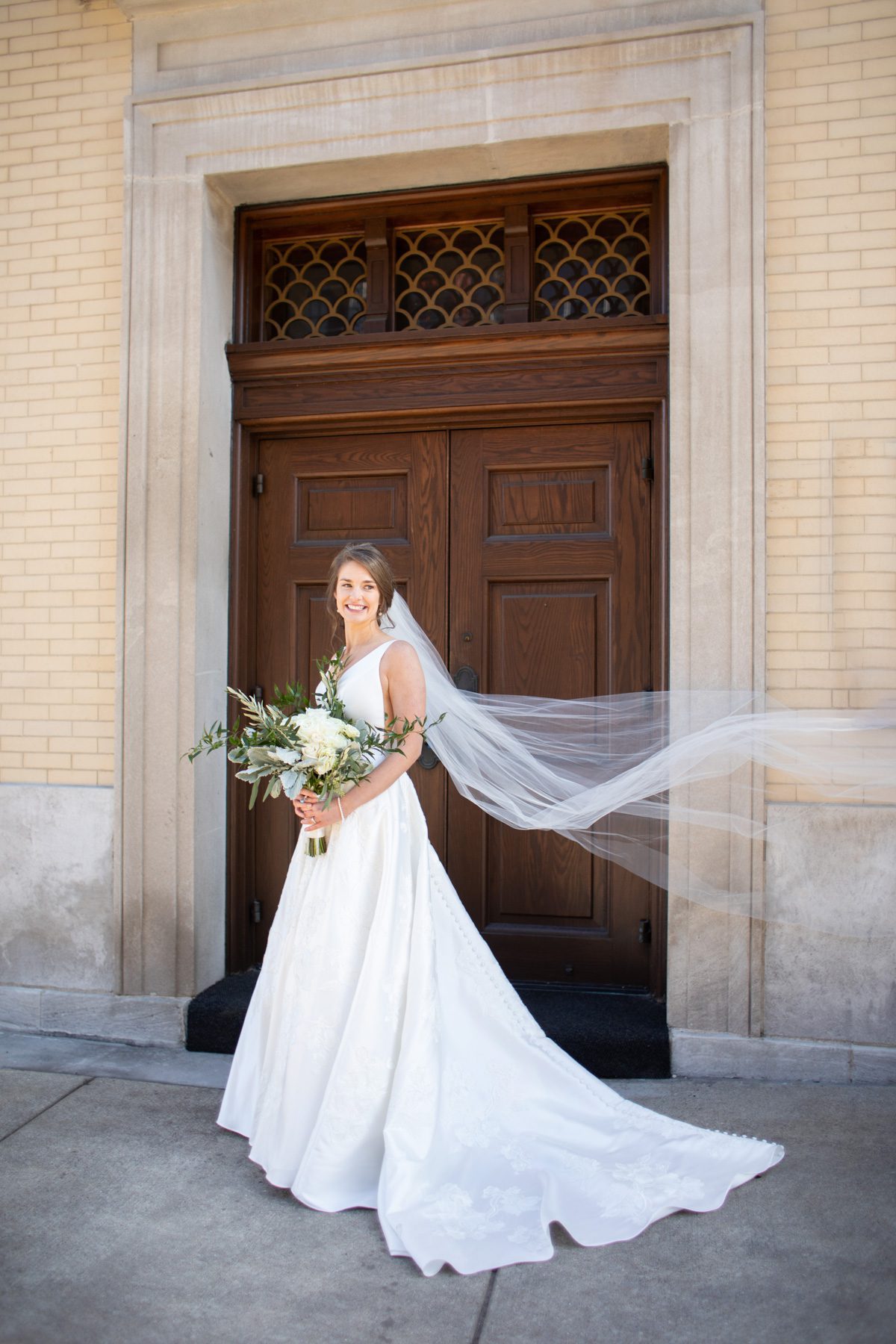 bride in front of doors on west end Cathedral of Incarnation Nashville TN